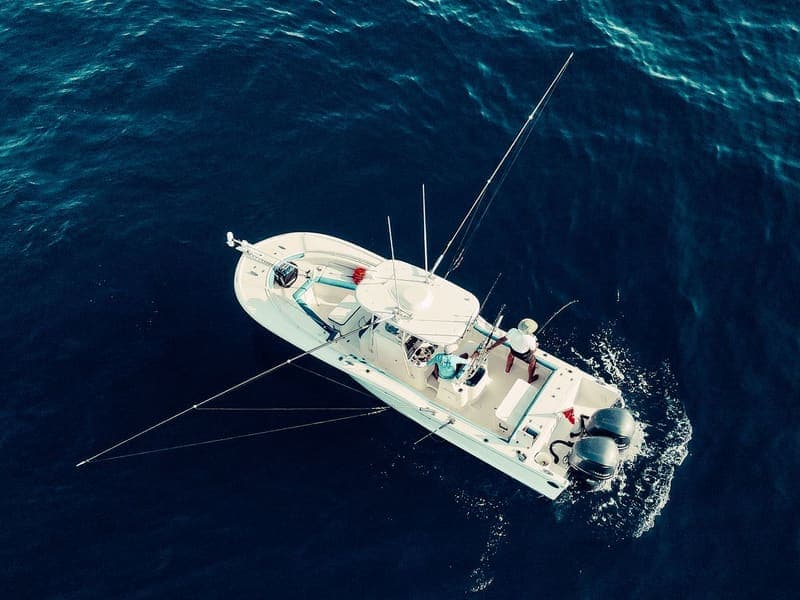 Sportfishing boat trolling offshore in deep blue water