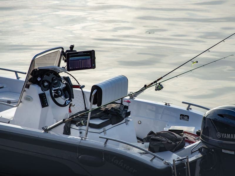 Center-console fishing boat rigged with rod and electronics